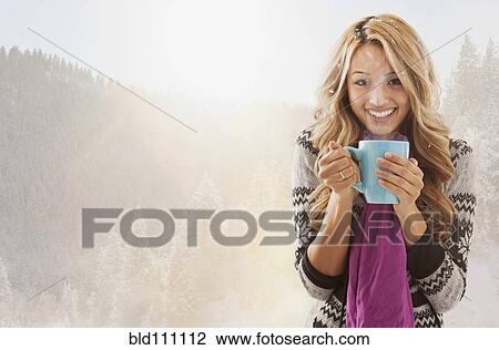 Mixed race woman drinking coffee in snow View Large Photo Image Stock Image - Mixed race woman drinking coffee in snow. Fotosearch