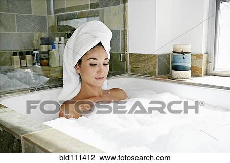 Mixed race woman having bubble bath View Large Photo Image Stock Image - Mixed race woman having bubble bath. Fotosearch