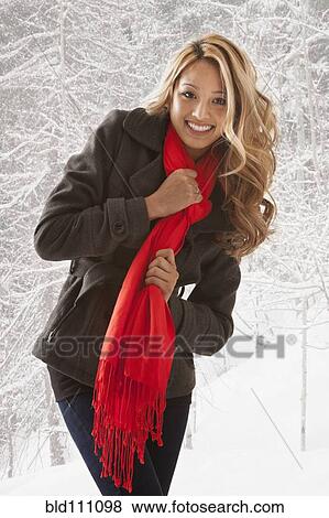 Mixed race woman smiling in snow View Large Photo Image Stock Photo - Mixed race woman smiling in snow. Fotosearch