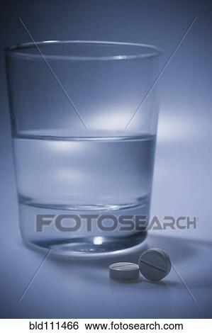 Stock Photograph - Pills and glass of water. Fotosearch