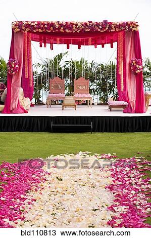 Stock Image - Pink and white flowers at Hindi wedding. Fotosearch