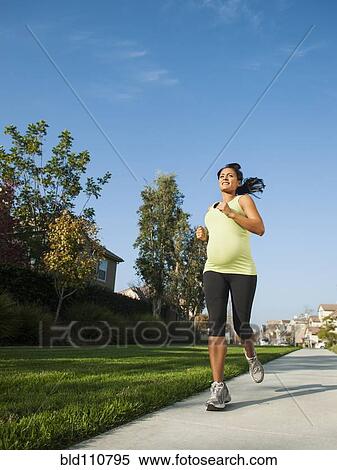 Pregnant Hispanic woman jogging in park View Large Photo Image Stock Photography - Pregnant Hispanic woman jogging in park. Fotosearch