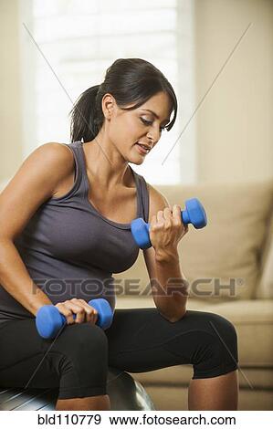 Pregnant Hispanic woman lifting weights View Large Photo Image Stock Photo - Pregnant Hispanic woman lifting weights. Fotosearch