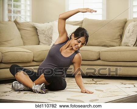 Pregnant Hispanic woman stretching View Large Photo Image Stock Image - Pregnant Hispanic woman stretching. Fotosearch