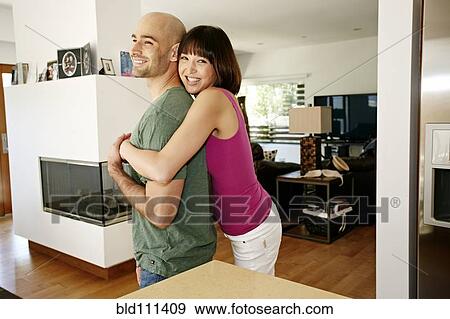 Smiling couple hugging in kitchen View Large Photo Image Stock Photo - Smiling couple hugging in kitchen. Fotosearch