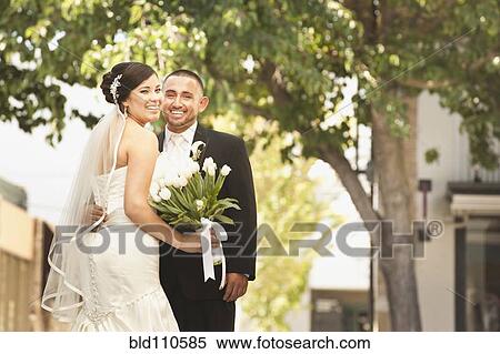 Stock Photography - Smiling Hispanic bride and groom. Fotosearch