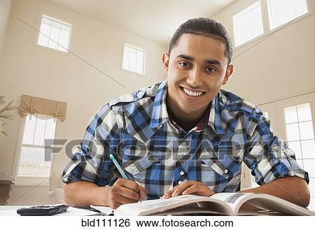 Stock Photograph - Smiling Hispanic man studying. Fotosearch