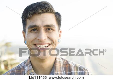Stock Photography - Smiling man standing outdoors. Fotosearch