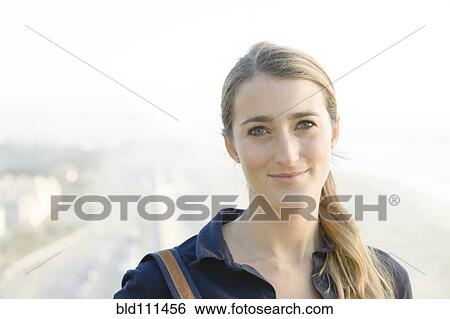 Stock Photograph - Smiling woman standing outdoors. Fotosearch