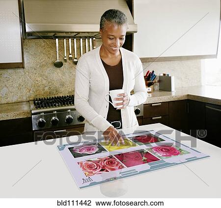 Smiling woman using computer in table View Large Photo Image Stock Image - Smiling woman using computer in table. Fotosearch