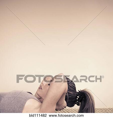 Woman doing sit-ups indoors View Large Photo Image Stock Image - Woman doing sit-ups indoors. Fotosearch