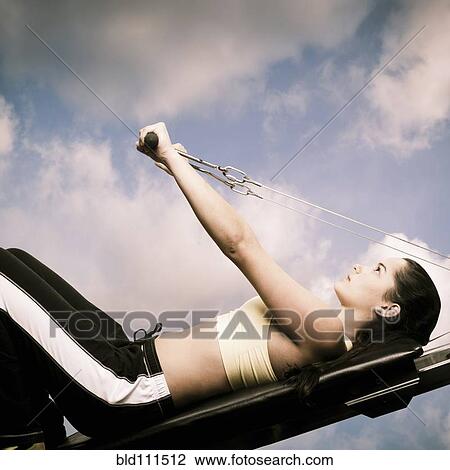 Woman using exercise machine outdoors View Large Photo Image Stock Image - Woman using exercise machine outdoors. Fotosearch