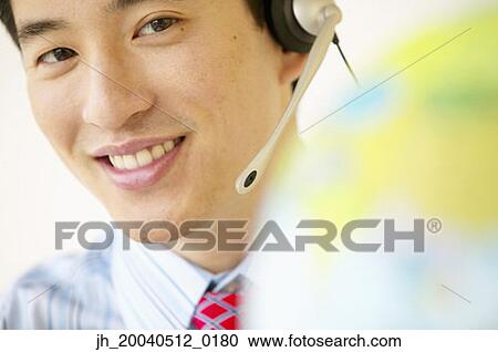 Portrait of a businessman wearing a headset View Large Photo Image Stock Image - Portrait of a businessman wearing a headset. Fotosearch