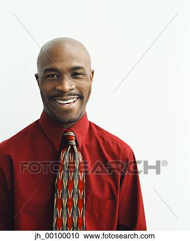 Portrait of a young businessman smiling View Large Photo Image Stock Image - Portrait of a young businessman smiling. Fotosearch
