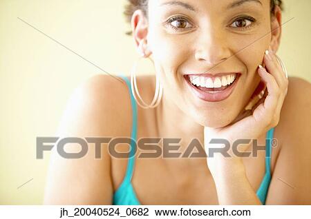 Portrait of a young woman smiling View Large Photo Image Stock Image - Portrait of a young woman smiling. Fotosearch