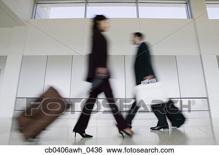 Stock Images of Side profile of two business executives walking past ...