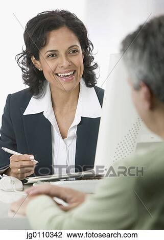 Two business executives sitting opposite each other talking View Large Photo Image Stock Image - Two business executives sitting opposite each other talking. Fotosearch