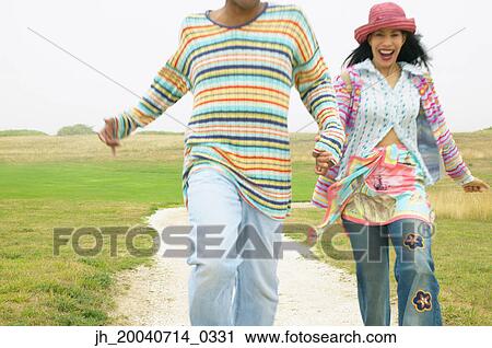 Stock Image - Couple walking together on a path. Fotosearch