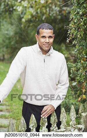 Man smiling for the camera outdoors View Large Photo Image Picture - Man smiling for the camera outdoors. Fotosearch
