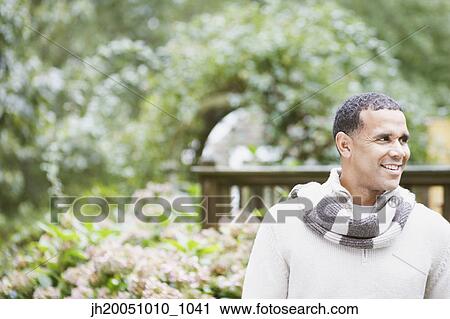 Man wearing a scarf outdoors View Large Photo Image Stock Image - Man wearing a scarf outdoors. Fotosearch