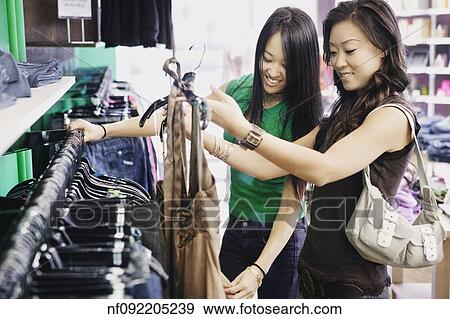 Stock Photo - Young women shopping. Fotosearch