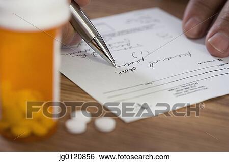Close up of man filling out prescription View Large Photo Image Stock Photograph - Close up of man filling out prescription. Fotosearch