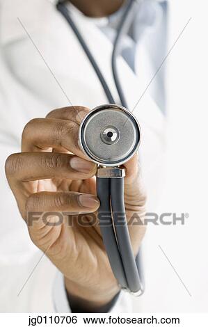 Human hand holding up a stethoscope View Large Photo Image Stock Photograph - Human hand holding up a stethoscope. Fotosearch