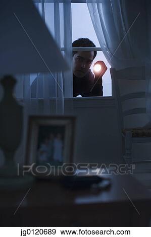 Thief peering in a window View Large Photo Image Stock Photo - Thief peering in a window. Fotosearch