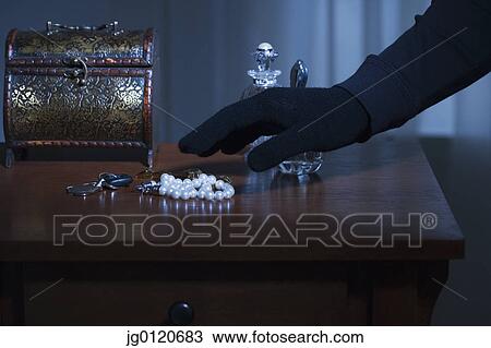 Thief reaching for a string of pearls View Large Photo Image Stock Image - Thief reaching for a string of pearls. Fotosearch