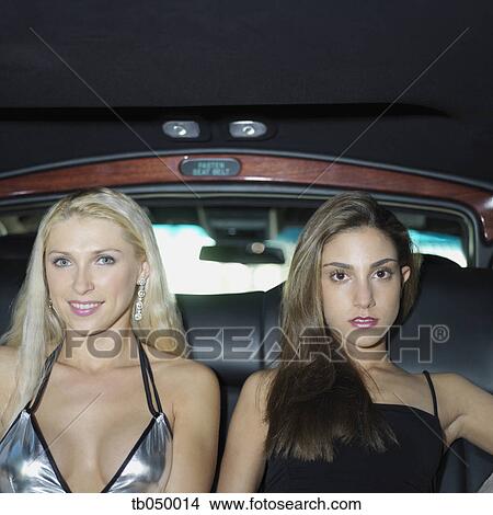 Two women in sexy dresses in the backseat of a limousine View Large Photo Image Picture - Two women in sexy dresses in the backseat of a limousine. Fotosearch