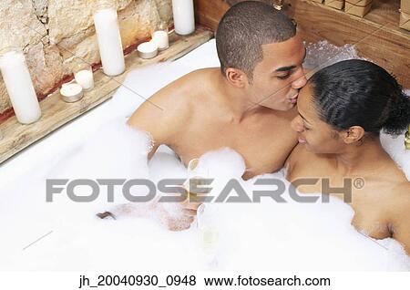 Young man kissing young woman in a bathtub View Large Photo Image Stock Photo - Young man kissing young woman in a bathtub. Fotosearch