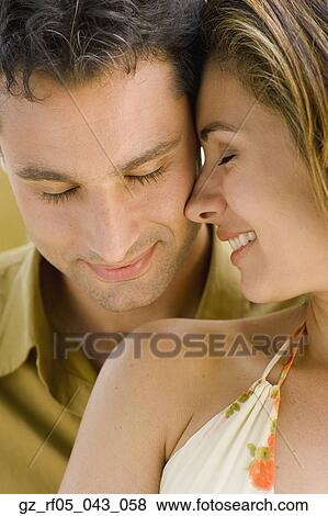 Close up of couple hugging View Large Photo Image Stock Photo - Close up of couple hugging. Fotosearch