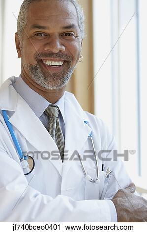 Stock Image - Middle-aged male African doctor smiling. Fotosearch