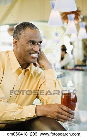 African American man with drink at bar View Large Photo Image Stock Image - African American man with drink at bar. Fotosearch