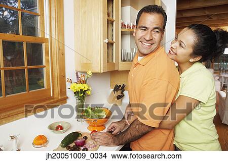 Picture - Couple cooking together. Fotosearch