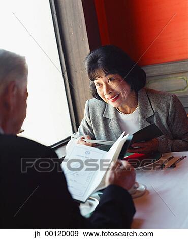 Senior couple sitting at a table in a restaurant View Large Photo Image Stock Photo - Senior couple sitting at a table in a restaurant. Fotosearch