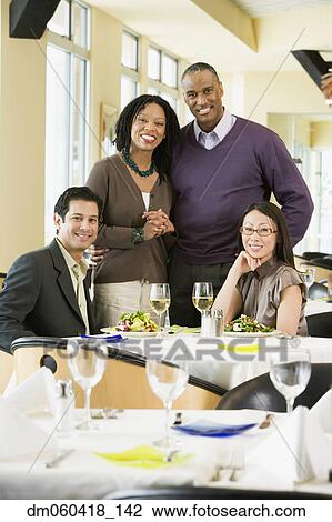 Stock Image - Two couples at restaurant. Fotosearch