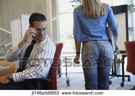 Businessman checking out female coworker View Large Photo Image Stock Image - Businessman checking out female coworker. Fotosearch