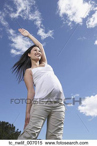 Pregnant Asian woman exercising outdoors View Large Photo Image Stock Photography - Pregnant Asian woman exercising outdoors. Fotosearch