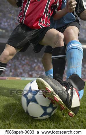 Stock Image - Soccer player stealing the ball. Fotosearch