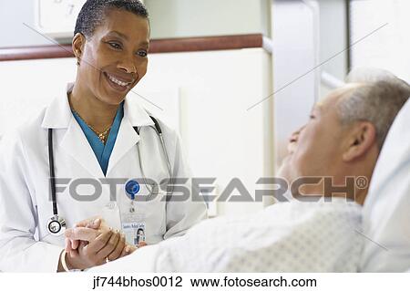 African female doctor with patient in hospital bed, Bethesda, Maryland, United States View Large Photo Image Stock Image - African female doctor with patient in hospital bed, Bethesda, Maryland, United States. Fotosearch