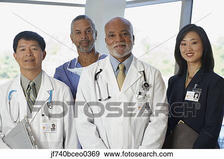 Group of doctors with Asian businesswoman View Large Photo Image Stock Photo - Group of doctors with Asian businesswoman. Fotosearch