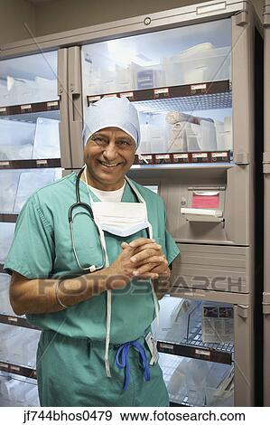 Middle-aged Indian male surgeon in supply room, Bethesda, Maryland, United States View Large Photo Image Stock Photo - Middle-aged Indian male surgeon in supply room, Bethesda, Maryland, United States. Fotosearch