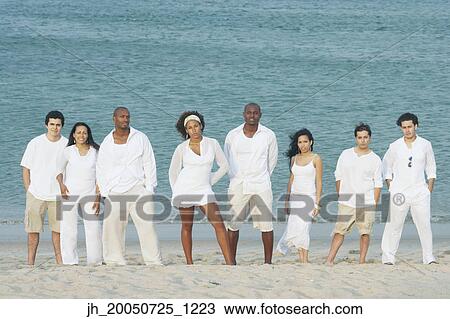Friends posing for the camera on the beach View Large Photo Image Stock Image - Friends posing for the camera on the beach. Fotosearch