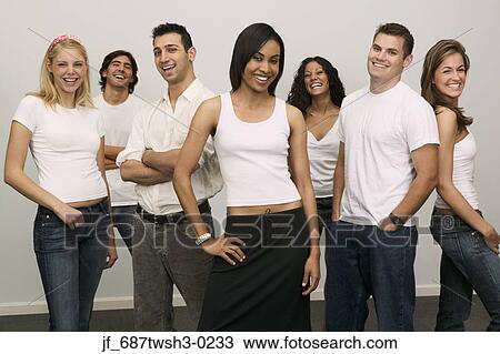 Group of young people standing looking at camera smiling View Large Photo Image Stock Image - Group of young people standing looking at camera smiling. Fotosearch