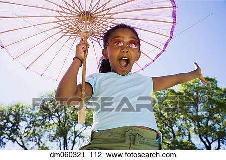 African American girl laughing with parasol outdoors View Large Photo Image Stock Image - African American girl laughing with parasol outdoors. Fotosearch