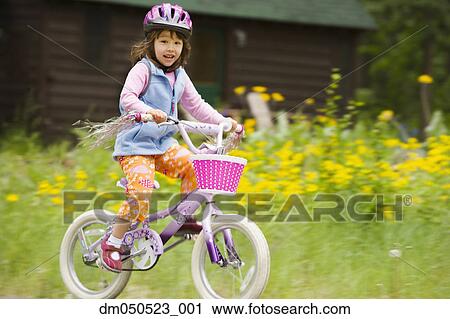 Stock Image - Portrait of girl riding bike. Fotosearch