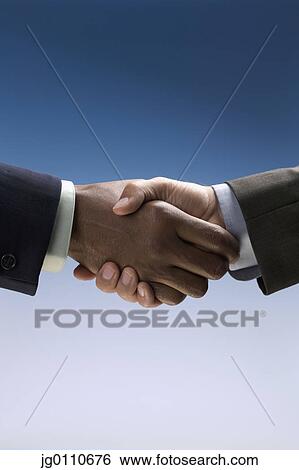 Stock Photograph - Businessmen shaking hands. Fotosearch