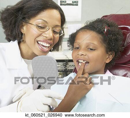 African female dentist young female patient View Large Photo Image Stock Image - African female dentist young female patient. Fotosearch