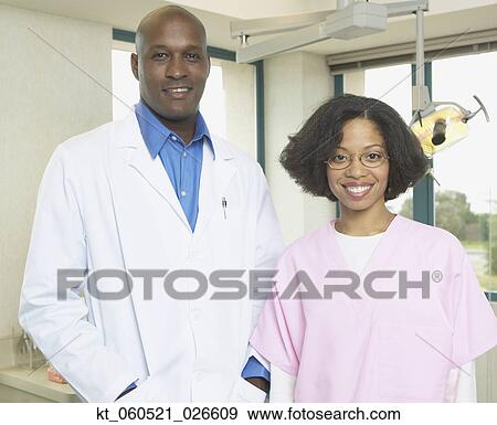 African male dentist with African female dental assistant smiling View Large Photo Image Stock Photo - African male dentist with African female dental assistant smiling. Fotosearch